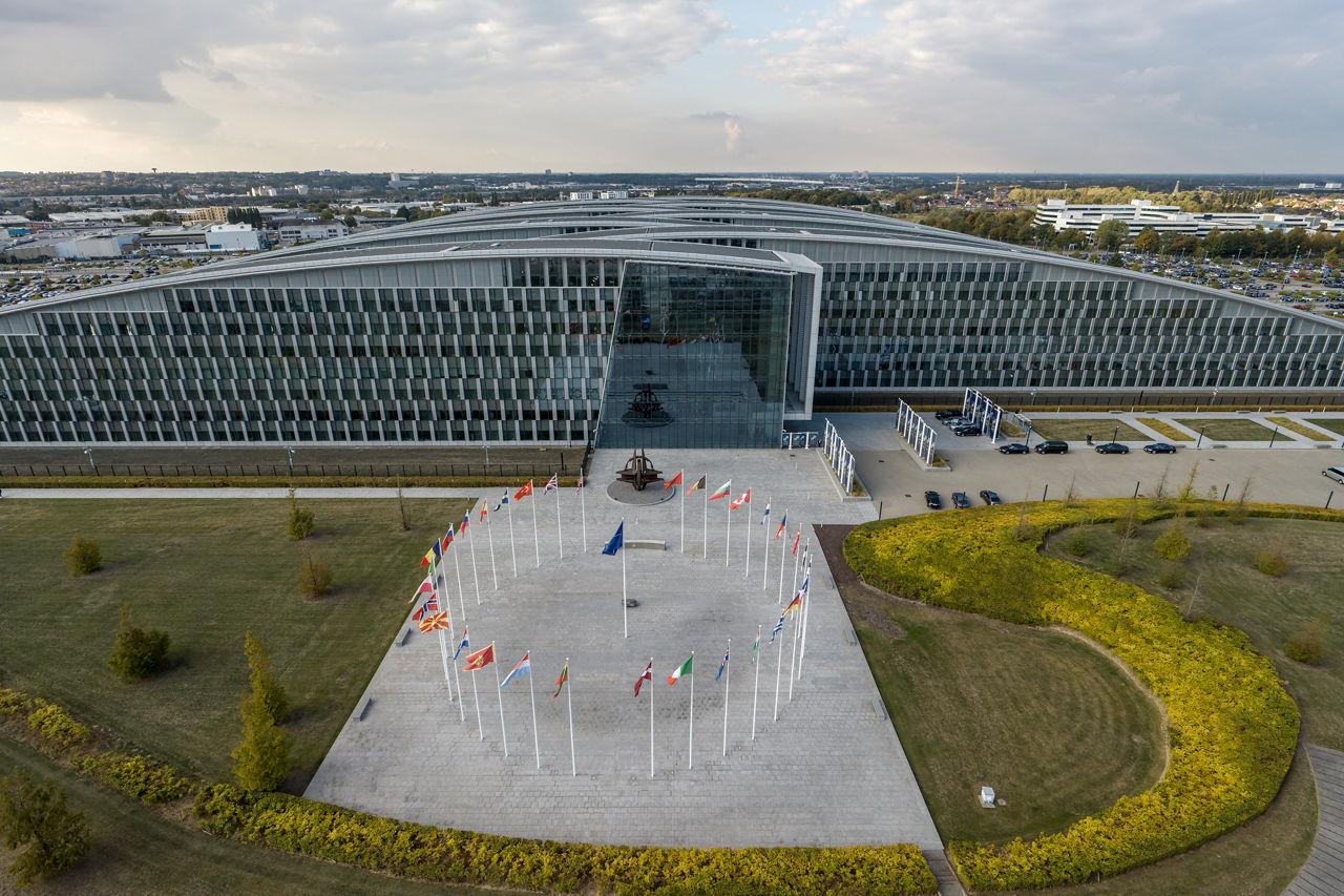 NATO headquarters in Brussels with the flags of the 32 member states in front of the building.