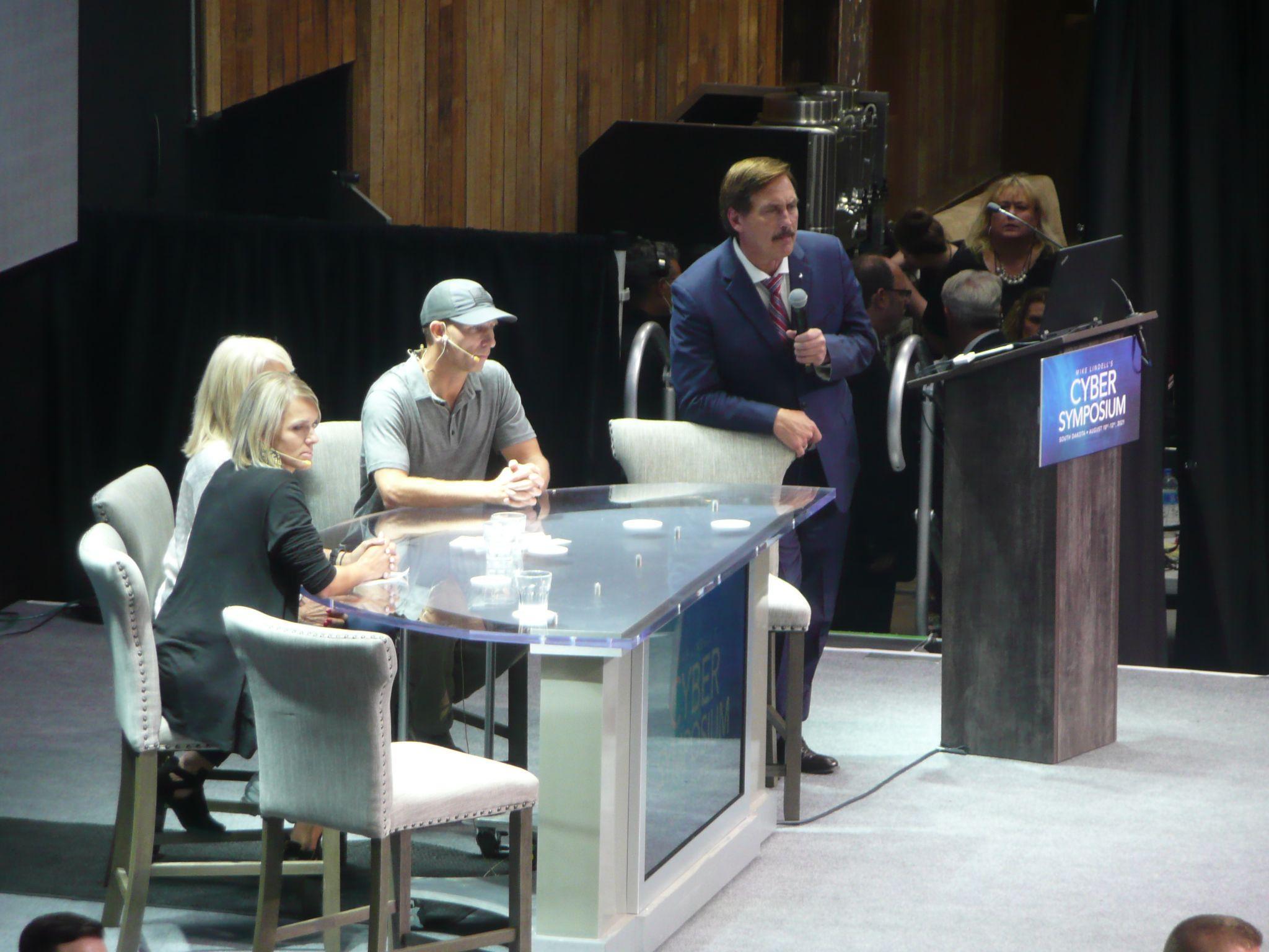 Mike Lindell (with microphone) introduces a panel from Mesa County, Colorado, at his Cyber Symposium, 10 August 2021. Among the panellists was Tina Peters, at the time the official responsible for elections in the county. Photo: Douglas W. Jones / Wikimedia Commons, CC0.